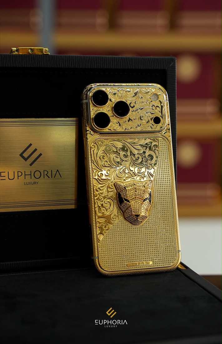 Gold iPhone with engraved panther beside a Euphoria Luxury presentation case